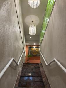 a staircase in a building with a chandelier at Downtown Santana Hotel in Rio de Janeiro