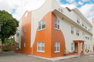 an orange and white building at Choose To Be Happy at The Westbury - Two Bedroom Apartment in Kingston