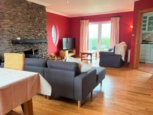 a living room with a couch and a fireplace at Wild Atlantic Haven in Ballyferriter