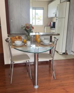a kitchen with a table with a bowl of food on it at Seara Host in Lages