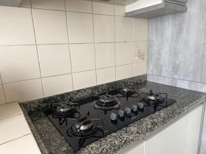 a kitchen stove with pots and pans on it at Seara Host in Lages