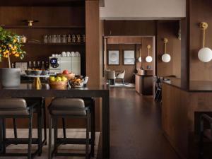 a kitchen with a table with a bowl of fruit at Fairmont Golden Prague in Prague