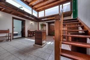 a living room with a staircase and a table at La Casucha - Typical Canarian House By Lanzarote Vacation Homes in Tías