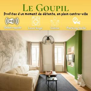 a living room with a couch and a table at Le Goupil in Chalon-sur-Saône