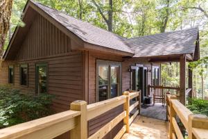 a log cabin with a porch and a wooden fence at Altitudes Attitude in Blowing Rock