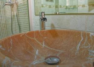 a sink with a faucet in a bathroom at Alojamiento Oasis Playa in Águilas +20 photos