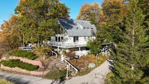 an overhead view of a white house with trees at Sunset Serenity - Incredible Home On Lake Bluff! in Frankfort