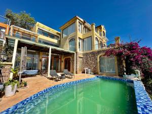 a house with a swimming pool in front of it at Dali Tanuki Fantasy Seaview Villa in Dali