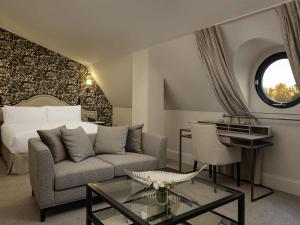 a living room with a couch and a bed at Fairmont Windsor Park in Windsor +273 photos