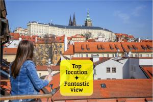 a woman standing on a roof with a top location sign at LH Vintage Design Hotel Sax in Prague