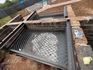 a metal grate on the side of a building at Glowti Event & Guest House in Centurion