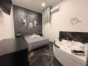 a bathroom with a bed and a tub and a sink at Belvedere Lacinio Guest House in Crotone