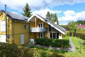 a yellow house with solar panels on it at Wildgans Classic 252 in Mirow