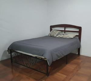 a bed in a room with a wooden bed frame at La Morada de sus Sueños Caeiro in Bialet Massé