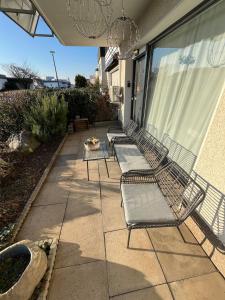 three chairs and a table on a patio at Cozy apartment in Hagen