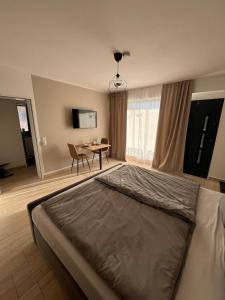 a bedroom with a bed and a table in it at Cozy apartment in Hagen