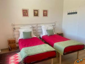 two beds sitting next to each other in a room at Perle de vue in Glaine-Montaigut +24 photos