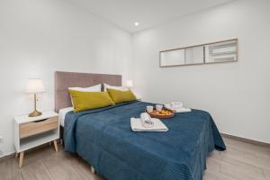 a bedroom with a bed with a tray of food on it at Sea View & Shared Pool in Lagos by HostWise in Lagos