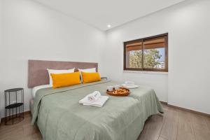 a bedroom with a bed with towels and a window at Sea View & Shared Pool in Lagos by HostWise in Lagos