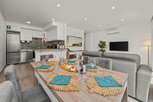 a dining room and kitchen with a table and chairs at Sea View & Shared Pool in Lagos by HostWise in Lagos