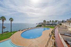 an overhead view of a swimming pool and the ocean at Sea View & Shared Pool in Lagos by HostWise in Lagos