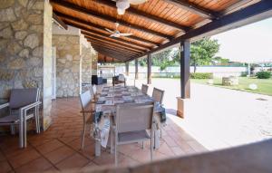 a patio with a long table and chairs at Villa Baia Del Circeo in Colonia Elena