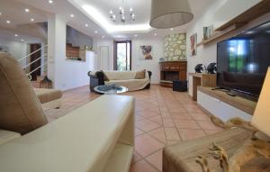 a living room with a couch and a television at Villa Baia Del Circeo in Colonia Elena