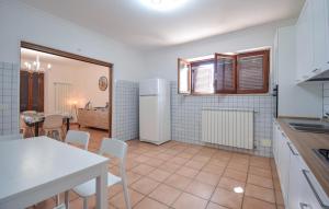 a kitchen and dining room with a table and chairs at Villa Baia Del Circeo in Colonia Elena