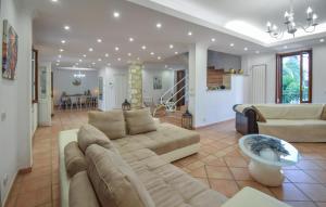a living room with a couch and a table at Villa Baia Del Circeo in Colonia Elena