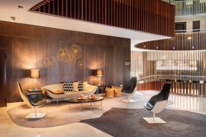 a living room with a couch and chairs in it at Meliá Sol y Nieve in Sierra Nevada