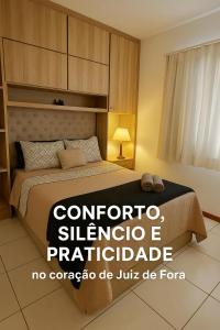 a bedroom with a bed and a sign that readscorporate sultanoterape at Maria Apê 04 Garagem ao lado do Independência Shopping in Juiz de Fora