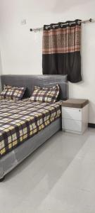 a bedroom with a bed and a curtain at dholavira dwarkadhish home stay in Dholovira