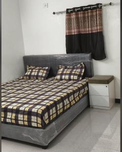 a bed with two pillows on it in a room at dholavira dwarkadhish home stay in Dholovira