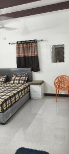 a bedroom with two beds and a table and a chair at dholavira dwarkadhish home stay in Dholovira