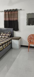 a bedroom with a bed and a table and a chair at dholavira dwarkadhish home stay in Dholovira