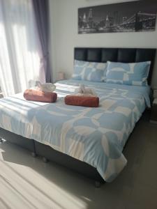 a bedroom with a large bed with two pillows on it at Maikhao Beach Condominium in Ban Bo Sai Klang
