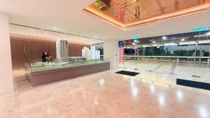 a lobby of a building with a woman standing in a store at Quill City Centre Residences Suites KLCC in Kuala Lumpur +70 photos
