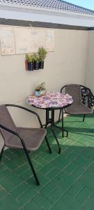 a table and two chairs on a patio at Studio On Fairway in Langebaan