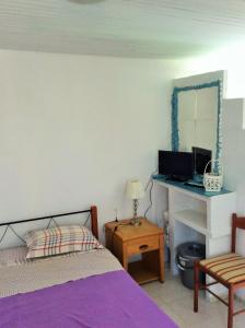 a bedroom with a bed and a desk with a computer at Villa Sofia in Ialysos +70 photos