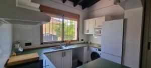 a small kitchen with a sink and a refrigerator at El Porche de Calabardina Playa - By Aloha Palma in Calabardina +10 photos