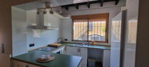 a kitchen with a counter and a sink and a window at El Porche de Calabardina Playa - By Aloha Palma in Calabardina