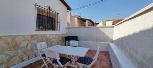 a white table and chairs on a patio at El Porche de Calabardina Playa - By Aloha Palma in Calabardina