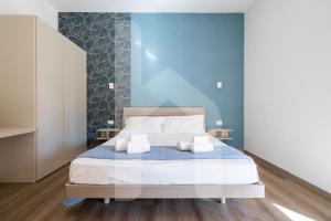 a bedroom with a bed with two pillows on it at Homiday - Residence Venere in Alba Adriatica +158 photos