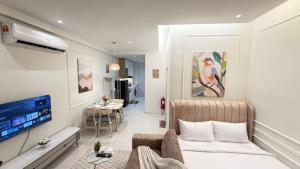 a living room with a couch and a tv in a room at Majestic Residence Suites KLCC in Kuala Lumpur