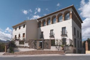 a large white building with windows and stairs at Elysium Luxury Stays in Melegis