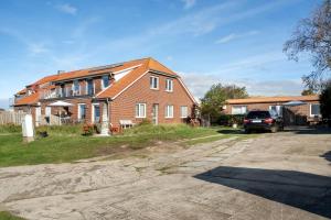 a brick house with a car parked in front of it at Opashus in Borkum