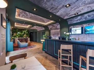 a bar in a restaurant with a stone wall at Mercure Bialystok in Białystok