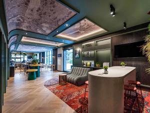 a lobby with a couch and a table in a room at Mercure Bialystok in Białystok