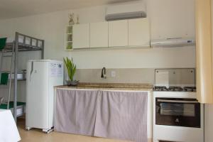 eine Küche mit Kühlschrank und Arbeitsplatte in der Unterkunft Casa Quintal Economic - Pé na Areia - Araçatiba Ilha Grande in Praia de Araçatiba + 11 Fotos
