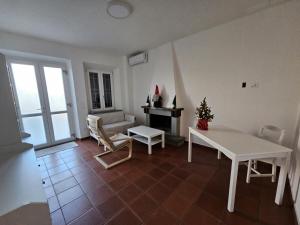 a living room with a white table and a couch at Affittacamere Clara in Lucca